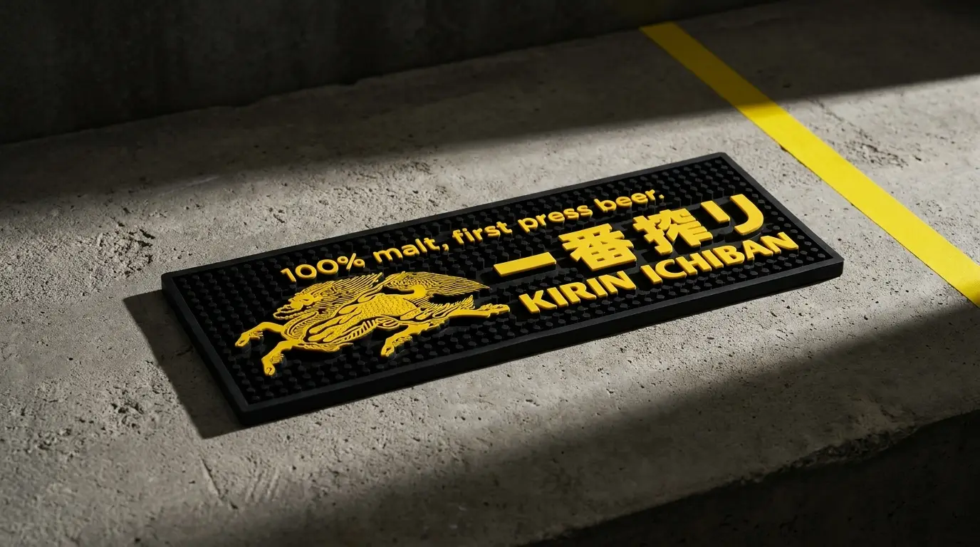 Custom Kirin Ichiban bar mat in black with yellow Kirin mascot and '100% malt, first press beer' branding, produced by SOS Station